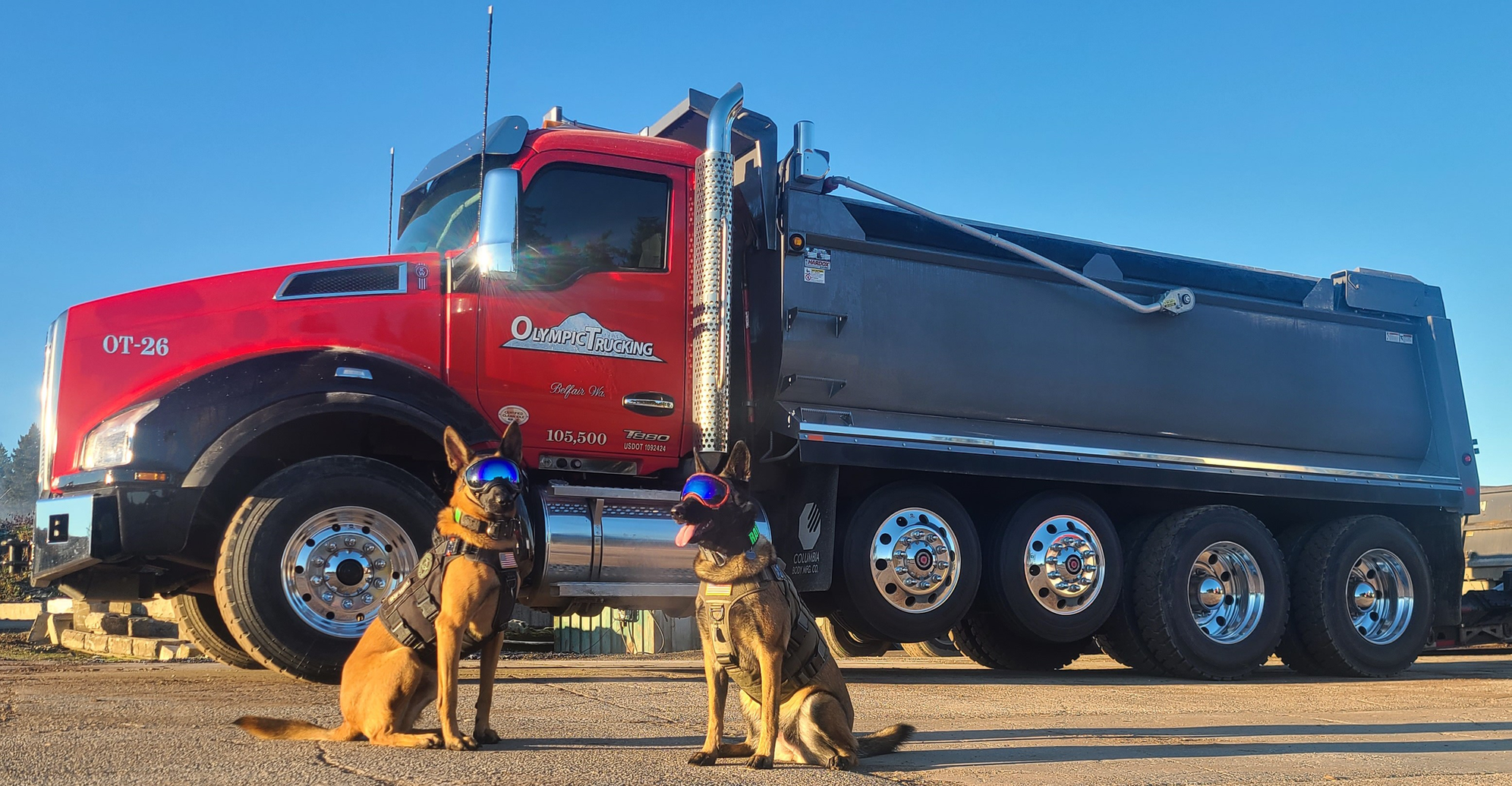 Ravenous Raven and Xena Maximus in Rex-Specs and tactical gear in front of the Olympic Trucking dump truck